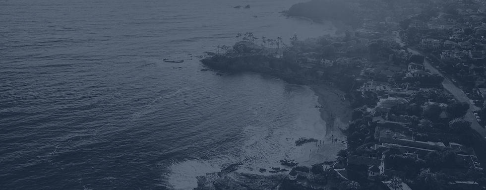 Aerial view of the Laguna Beach coastline and hillside homes