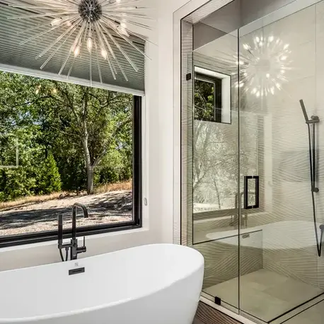 Freestanding tub and glass shower beside a picture window in Somerset, CA