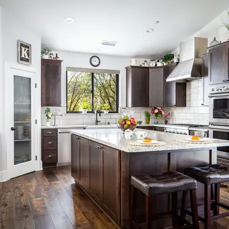 Kitchen with dark cabinets, a granite island and subway tile in The Sierra semi-custom home