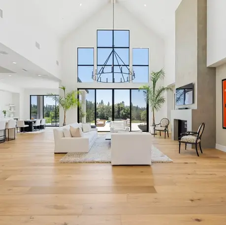 Two-storey great room with a gable window wall and iron chandelier in Meadow Vista, CA