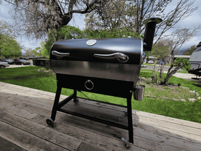 Black and stainless steel recteq pellet grill with digital controller set up on a backyard deck in Carson City, Nevada