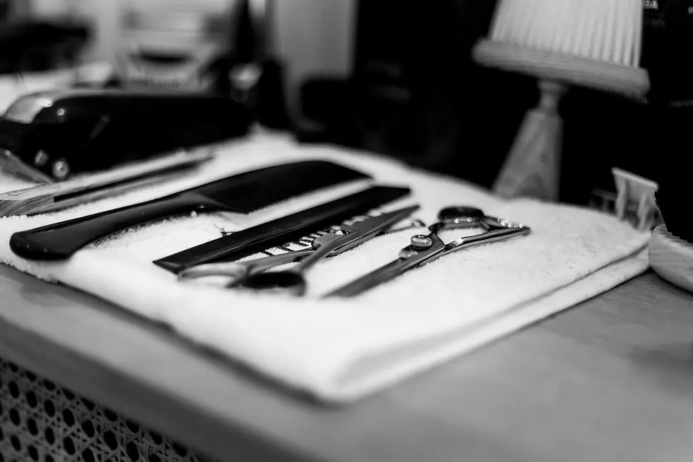 Barber tools and scissors arranged on a towel at Barbery Coast barber shop in North Beach, San Francisco.