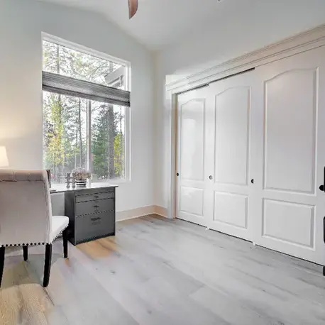 Bedroom with a desk nook and double closet in The Motherlode
