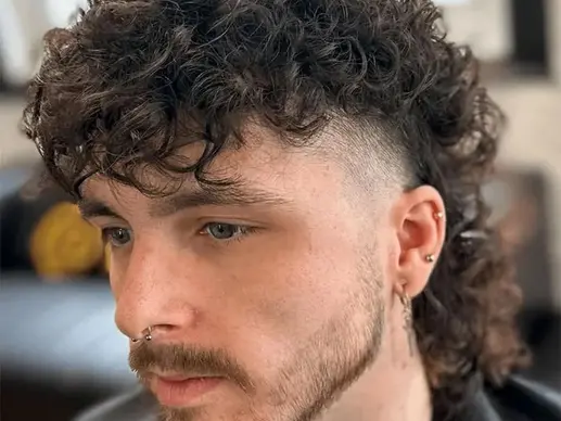 Men's curly mullet haircut at Barbery Coast Barber Shop in North Beach San Francisco