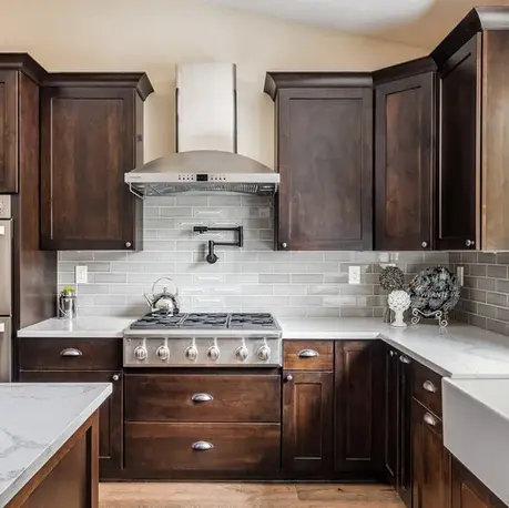 Gas range with pot filler and subway tile backsplash in The Alpine custom home kitchen