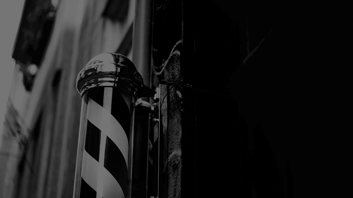 Classic barber pole outside Barbery Coast Barber Shop