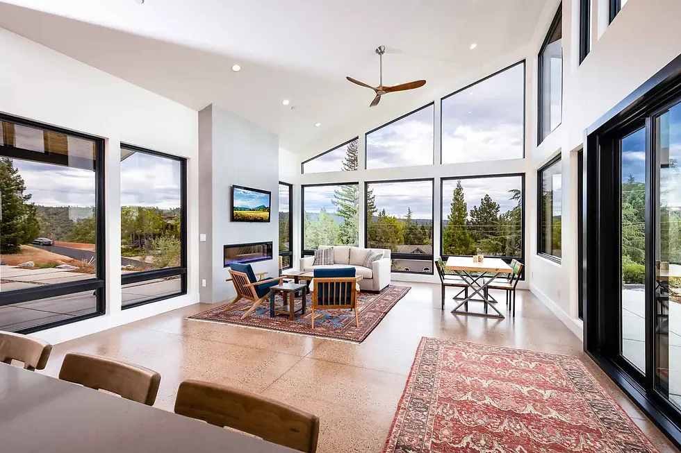 Open-concept great room in a custom Placer County home with vaulted ceiling, two-story window wall and white oak floors