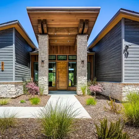 Entry portico with stone columns and a cedar soffit in Somerset, CA