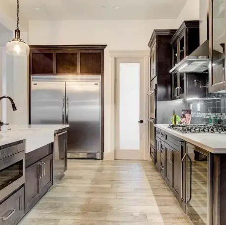 Prep sink, built-in refrigerator and pantry door in The Motherlode kitchen