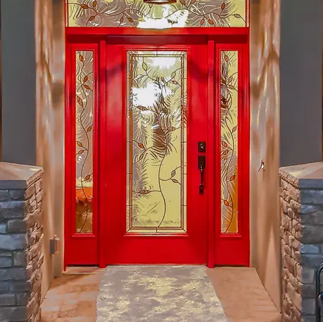 Red front door with etched glass panels and a stone surround on an Auburn custom home