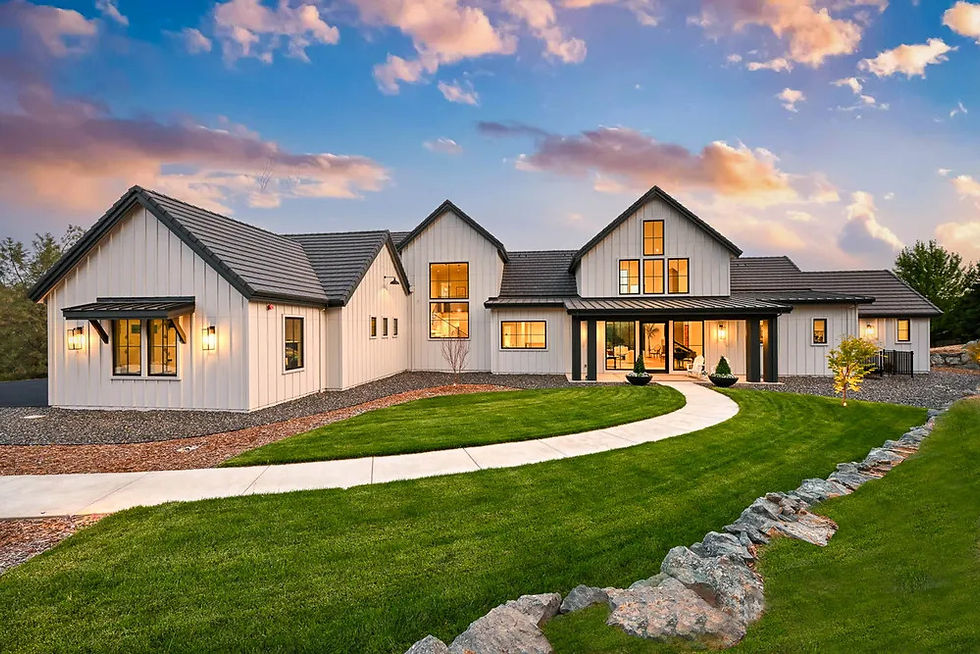Modern farmhouse custom home lit at dusk with a curved walkway in Meadow Vista, CA