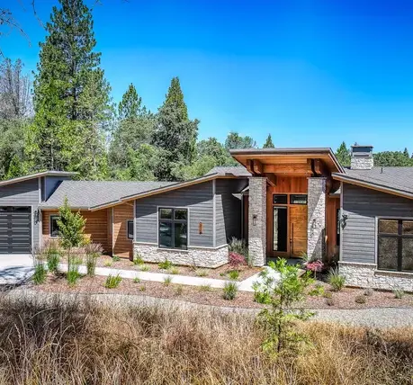Front approach with stone wainscot and cedar-clad entry in Somerset, CA