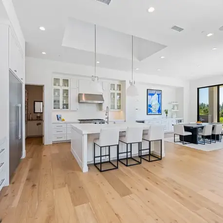 White kitchen with a quartz island and glass-front cabinets in Meadow Vista, CA