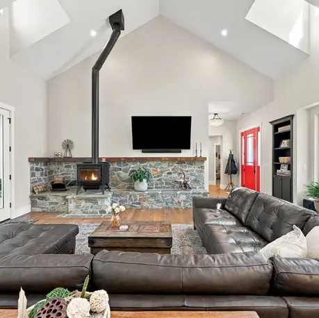 Great room with wood stove on a stacked-stone hearth