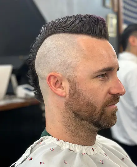 High skin fade haircut with longer styled top at Barbery Coast Barber Shop