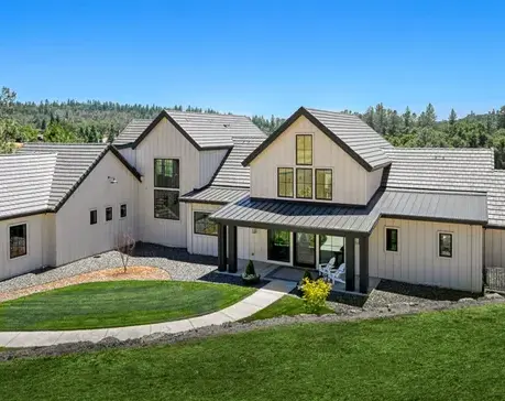 Board-and-batten farmhouse elevation with standing-seam porch roof in Meadow Vista, CA