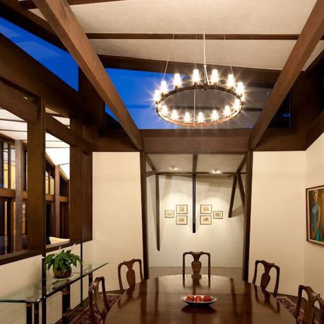 Dining room with exposed timber beams and an iron chandelier at Canopy House