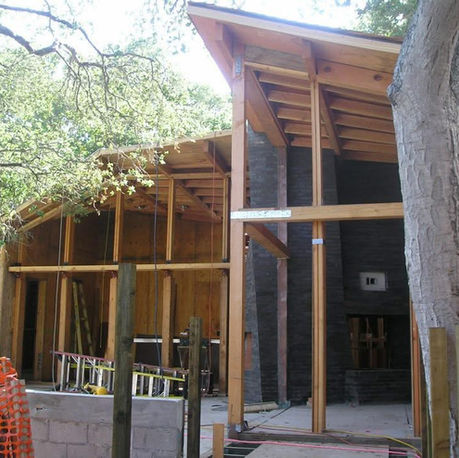Framed walls and roof structure built around an existing oak at Canopy House