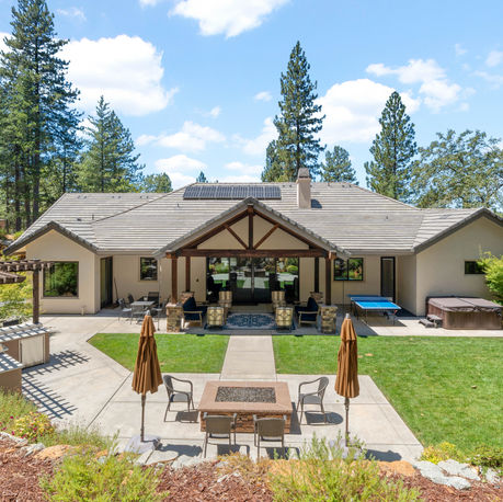 Backyard overview with pergola, lawn and covered patio at The Ridge