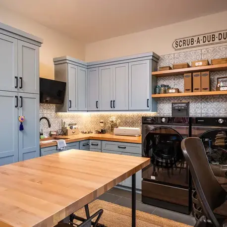 Laundry room with blue cabinetry, a butcher-block island and patterned tile in Christian Valley, CA