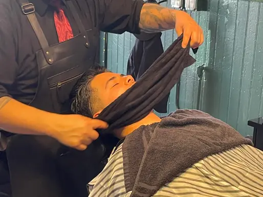 Hot towel shave preparation at Barbery Coast Barber Shop in North Beach San Francisco