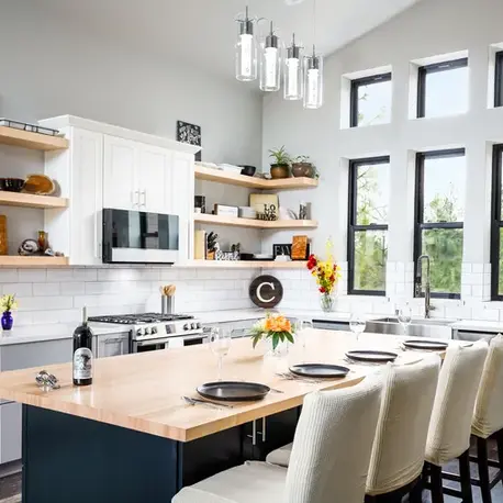 White kitchen with butcher-block island, open shelving and clerestory windows in a Colfax custom home