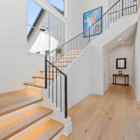White oak staircase with a black iron railing in Meadow Vista, CA