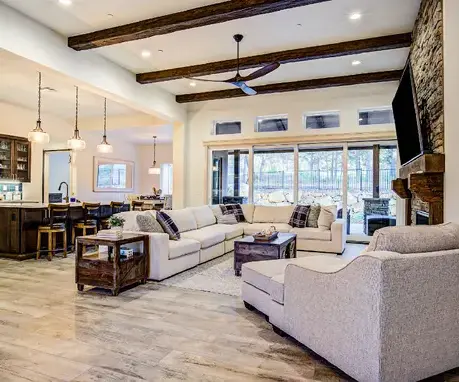 Great room with beamed ceiling opening to the kitchen in The Motherlode
