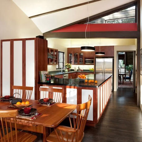 Kitchen with cherry cabinetry and a dark stone island at Canopy House, Carmel-by-the-Sea