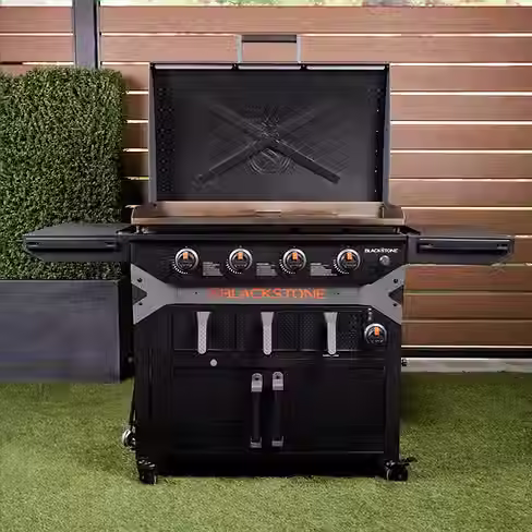 Blackstone griddle with hood open and cabinet base for outdoor cooking at Wickstrom Ace Hardware in Carson City, NV.