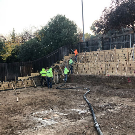 Crew placing concrete in the retaining wall forms in Rocklin, CA