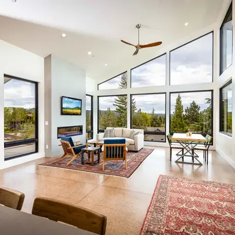 Vaulted living room with a wall of windows framing the foothills in Auburn Lake Trails, CA