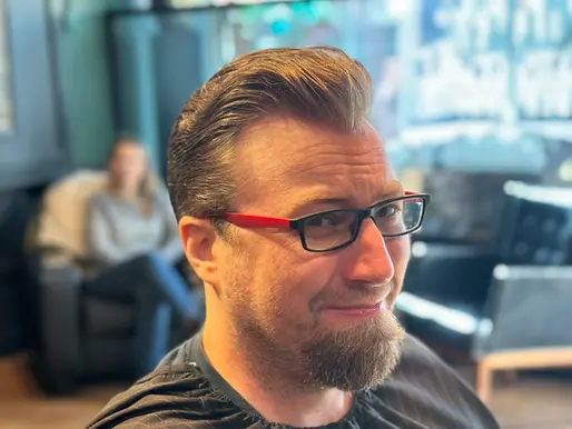 Men's classic slicked-back haircut at Barbery Coast Barber Shop in North Beach San Francisco