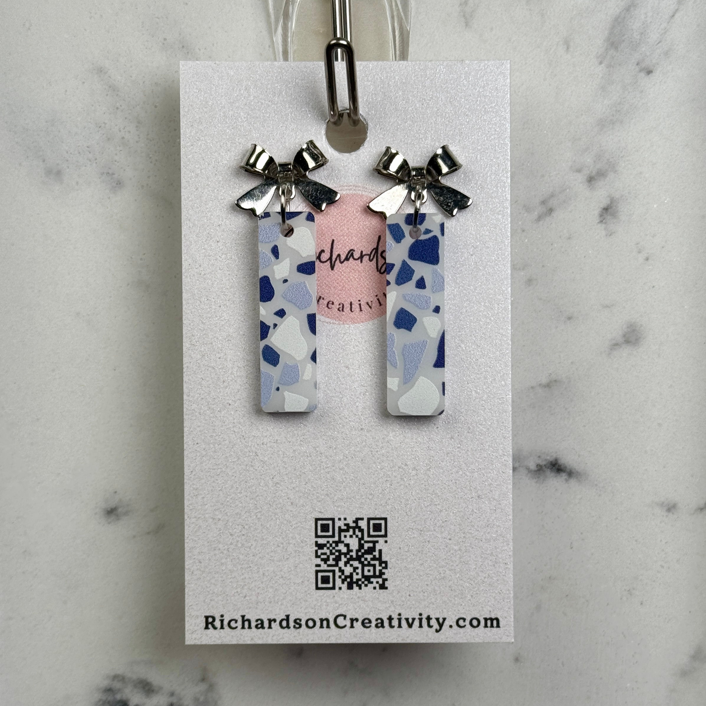 blue and white acrylic bars with silver bow topper earrings