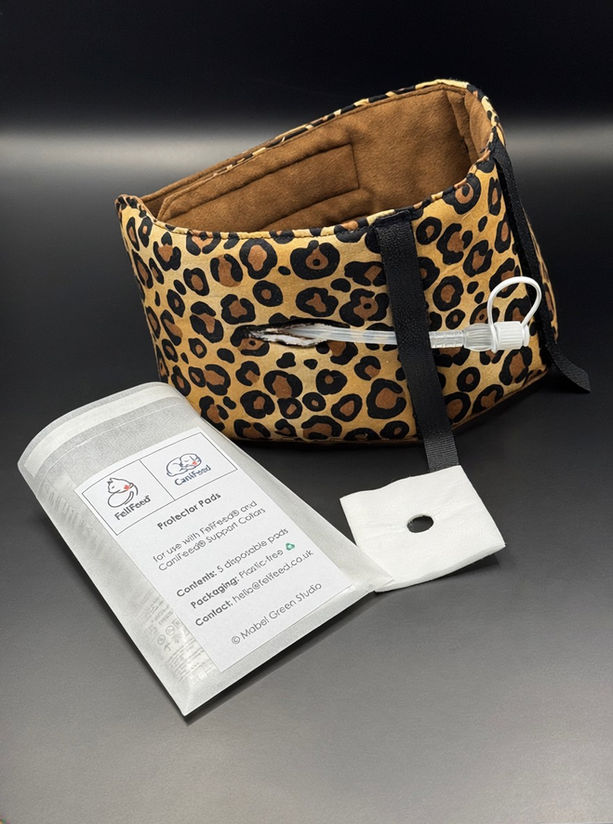 A set of single‑use wound‑care pads shown laid flat. Each pad has a low‑adherent contact layer with small perforations to allow fluid to pass into the absorbent core. A precisely cut circular centre opening is visible on each pad, designed to fit around an oesophagostomy feeding tube when used with FeliFeed® or CaniFeed® Support Collars.