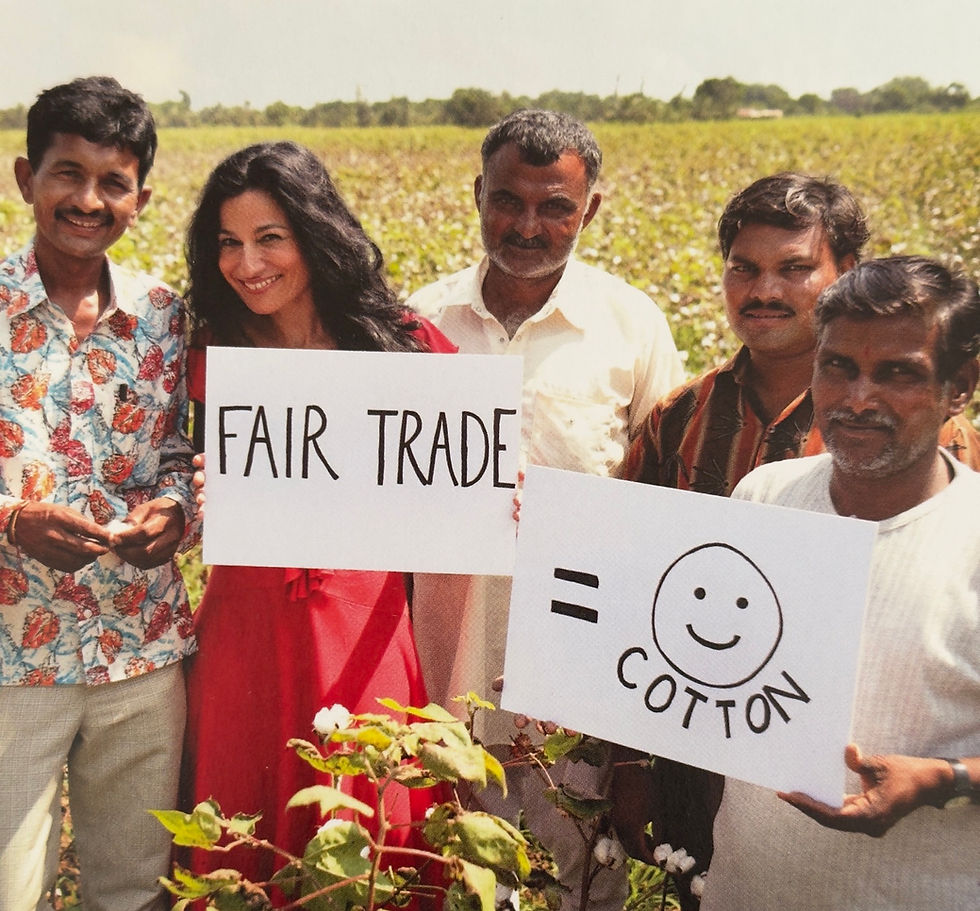 Safia Minney with cotton farmers in India stood in a cotton field.