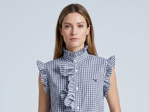 Female model wearing a blue and white checked frilled blouse reworked from a cotton men's shirt