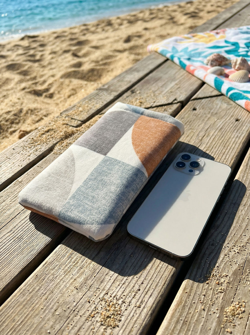 Padded iPhone case next to phone on beach boardwalk