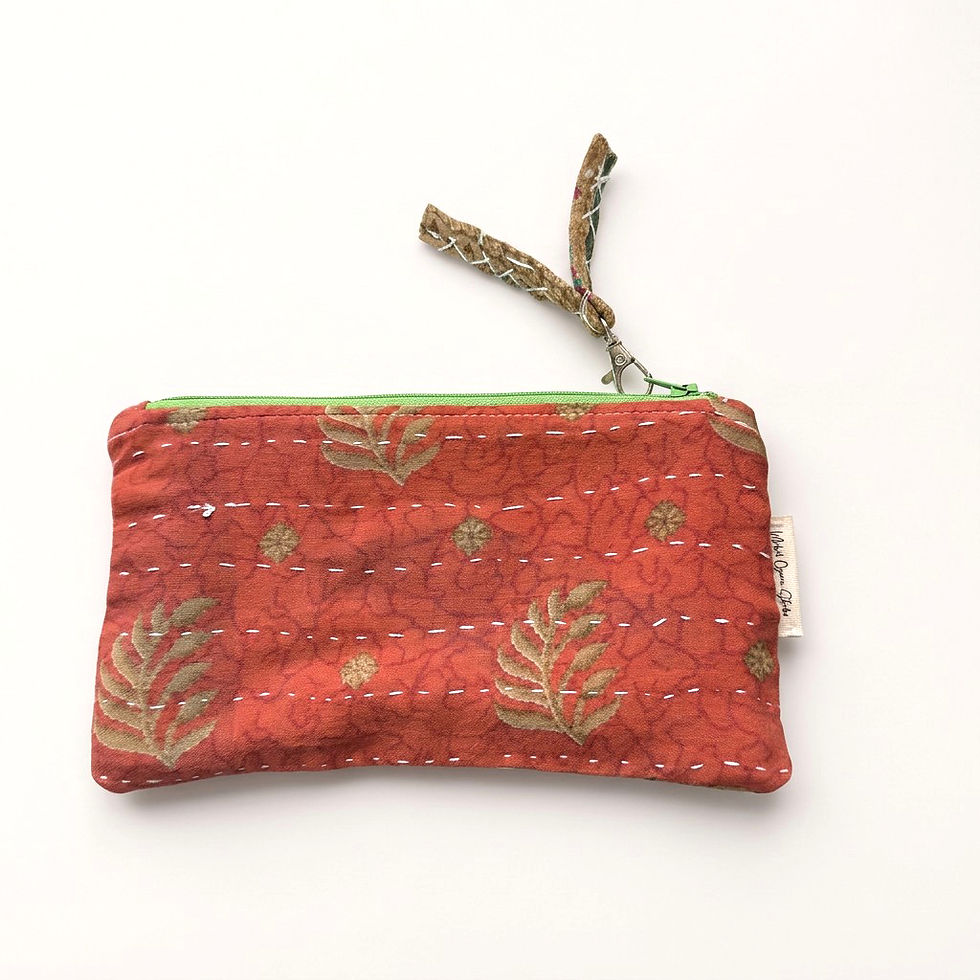 Red fabric pouch with leaf pattern and green zipper
