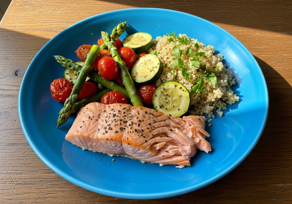 Salmon with asparagus, tomatoes and quinoa on a contrasting blue plate. Wooden table background.