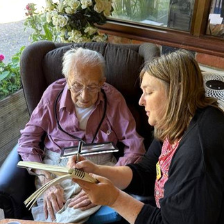 A companion helps an elderly gentleman