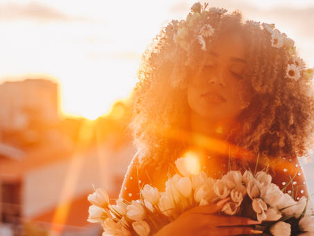 Woman holding roses in sunlight