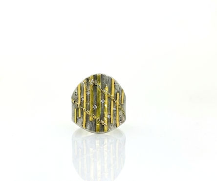 Gold is fused onto this silver ring with diamonds.
