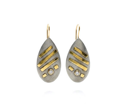 Gold is fused onto these silver earrings with diamonds.