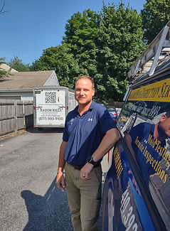 Francis Glynn, inspector, standing by company truck.