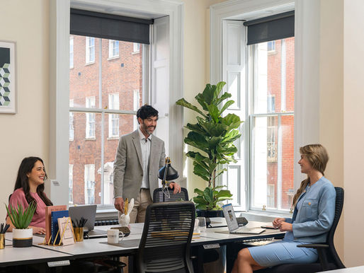 3 colleagues interacting in a private office 