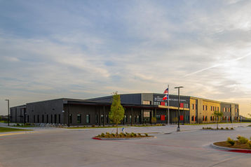 Wide exterior view of Dorothy Martinez Elementary School clad in Black Beauty thin brick in American Imperial size by Acme, showing the full building facade and landscaped campus.