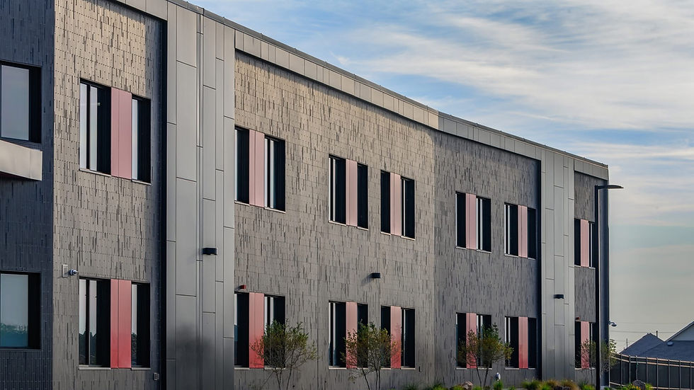 sun gleaming on thin brick along side of elementary school