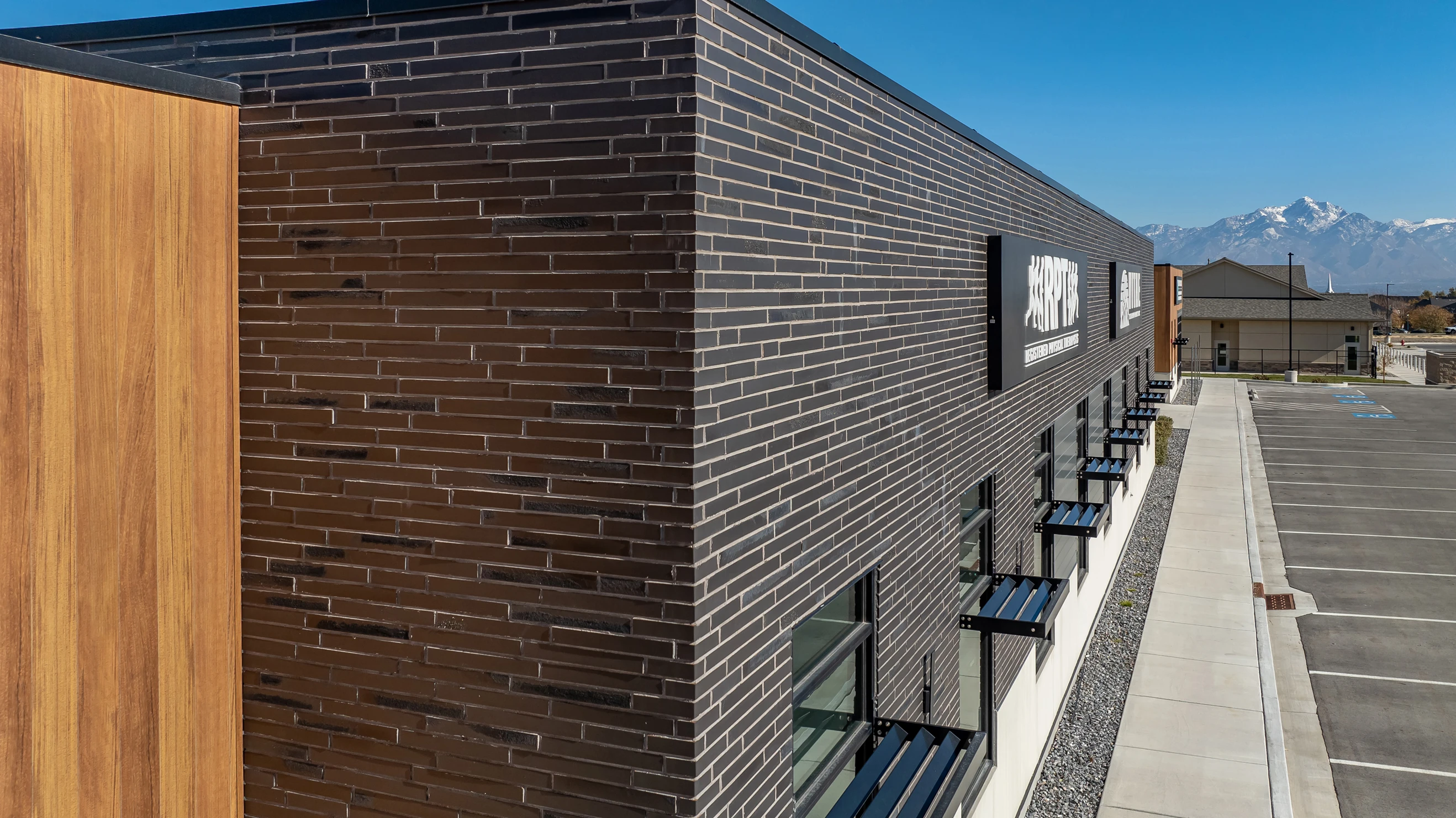 Dark thin brick and wood accents create a modern medical office exterior.