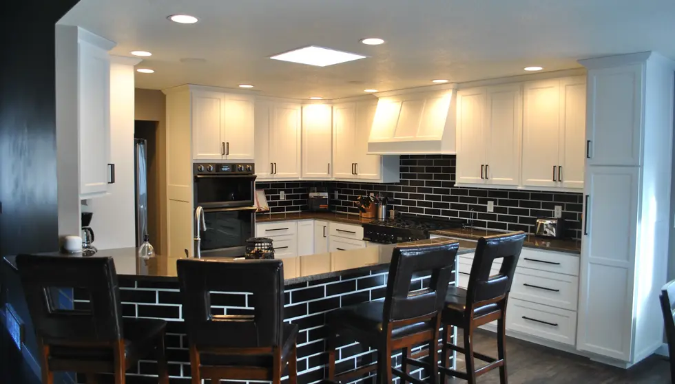 Contemporary kitchen with island clad in Onyx Black Glazed King Size thin brick and matching black brick backsplash.